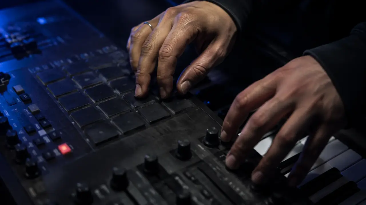 AI-generated concept image of hands working with a sampler and keyboard, not an actual studio session.